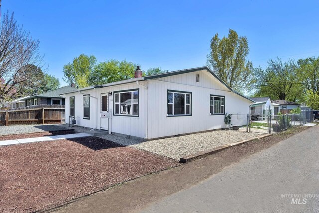 2323 W Lemhi St, Boise, ID 83705 - manufactured / mobile home with a gate, fence, and a chimney