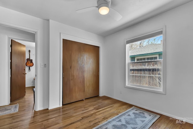 2323 W Lemhi St, Boise, ID 83705 - unfurnished bedroom with baseboards, ceiling fan, wood finished floors, and a closet
