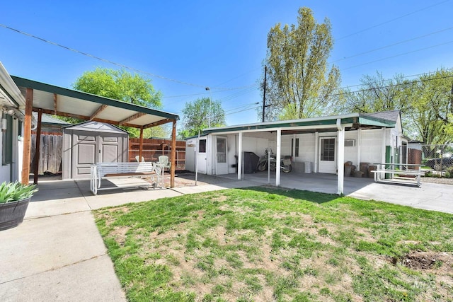 2323 W Lemhi St, Boise, ID 83705 - rear view of house with a storage shed, an outdoor structure, a fenced backyard, a yard, and a patio