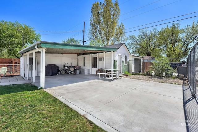 2323 W Lemhi St, Boise, ID 83705 - back of house featuring fence, a carport, and concrete driveway