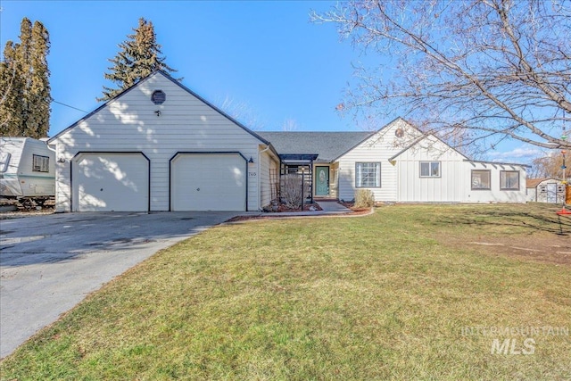 ranch-style house featuring a garage and a front yard