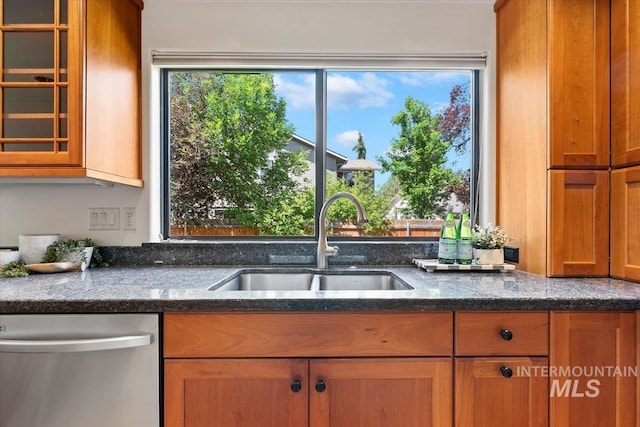 1814 E Spinnaker Ct, Boise, ID 83706 - kitchen with dishwasher, a sink, glass insert cabinets, brown cabinetry, and dark stone counters