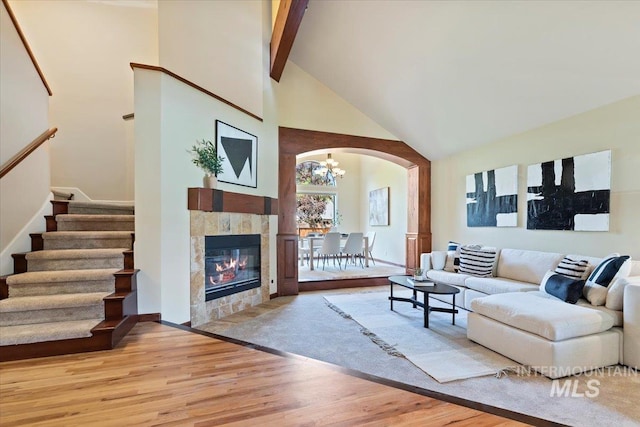 1814 E Spinnaker Ct, Boise, ID 83706 - living area featuring arched walkways, high vaulted ceiling, light wood-type flooring, a chandelier, and stairs