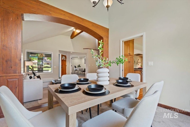 1814 E Spinnaker Ct, Boise, ID 83706 - dining area featuring light carpet, arched walkways, baseboards, and high vaulted ceiling