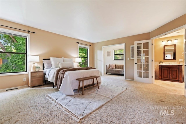 1814 E Spinnaker Ct, Boise, ID 83706 - bedroom with carpet flooring, ensuite bathroom, baseboards, and french doors
