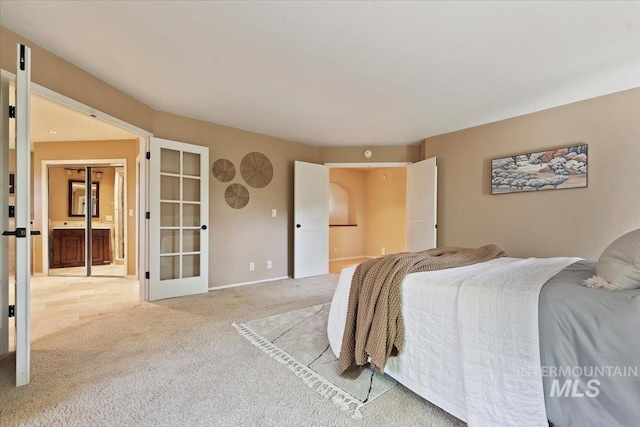 1814 E Spinnaker Ct, Boise, ID 83706 - bedroom featuring french doors, light carpet, ensuite bath, and baseboards