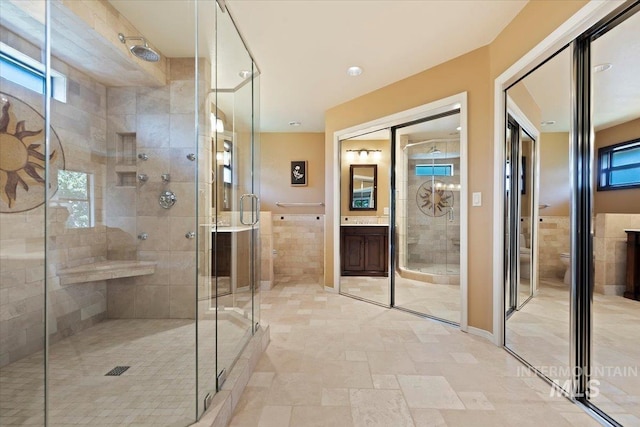 1814 E Spinnaker Ct, Boise, ID 83706 - bathroom with a stall shower, vanity, toilet, and tile walls