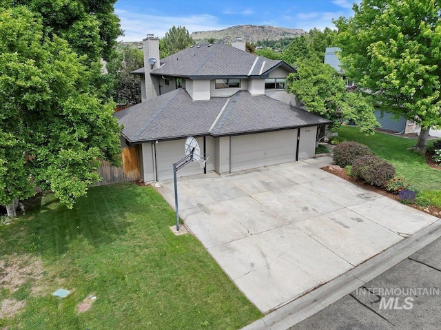 1814 E Spinnaker Ct, Boise, ID 83706 - view of front of home with a garage, driveway, a chimney, roof with shingles, and a mountain view