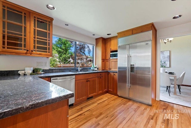 1814 E Spinnaker Ct, Boise, ID 83706 - kitchen featuring stainless steel appliances, a sink, brown cabinetry, light wood-style floors, and recessed lighting