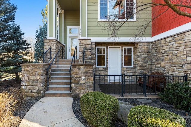 view of exterior entry featuring stone siding