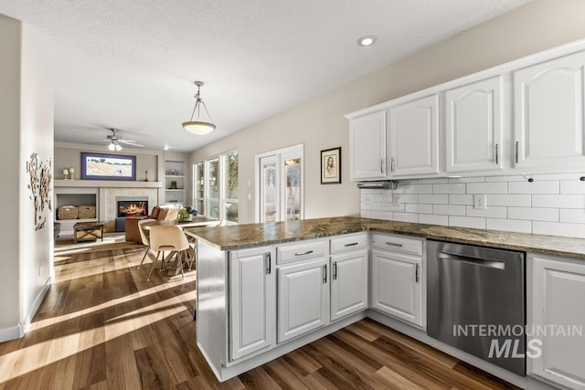 kitchen with white cabinetry, decorative light fixtures, dark wood-type flooring, and kitchen peninsula