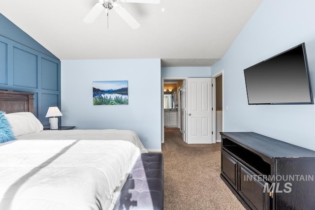 carpeted bedroom featuring lofted ceiling, connected bathroom, and ceiling fan