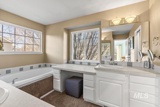 bathroom featuring vanity and a washtub