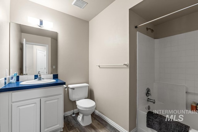 full bathroom featuring shower / bathing tub combination, vanity, hardwood / wood-style flooring, and toilet