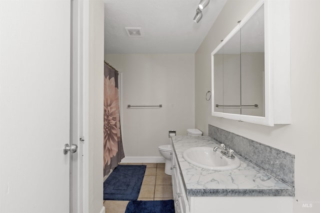 101 Patton St, Marsing, ID 83639 - bathroom featuring vanity, tile patterned flooring, toilet, baseboards, and curtained shower