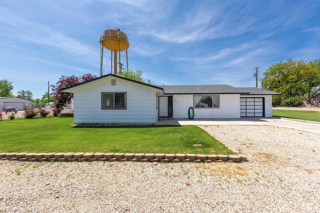 101 Patton St, Marsing, ID 83639 - view of front facade with an attached garage, concrete driveway, and a front lawn
