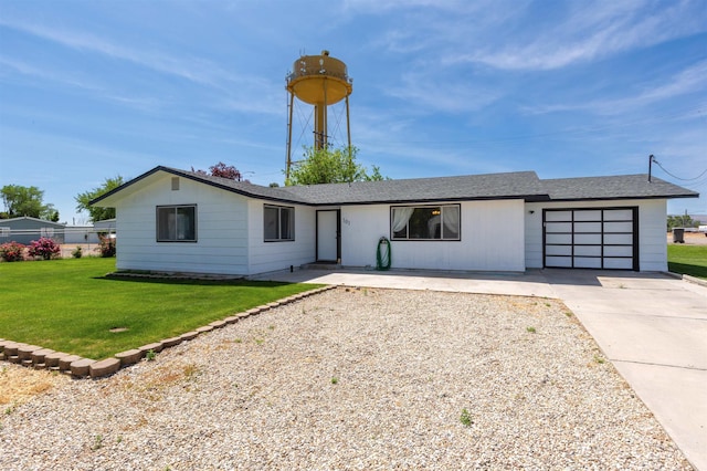 101 Patton St, Marsing, ID 83639 - view of front of house with a garage, driveway, and a front lawn