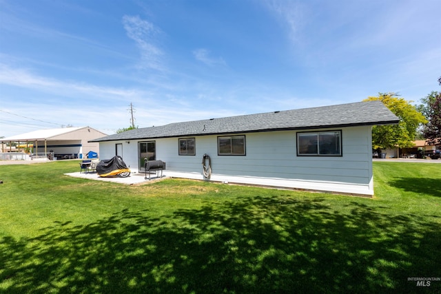 101 Patton St, Marsing, ID 83639 - rear view of house featuring a yard, a patio, and a shingled roof