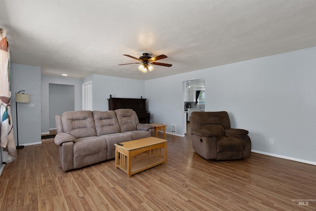101 Patton St, Marsing, ID 83639 - living area featuring a ceiling fan, light wood-type flooring, and baseboards