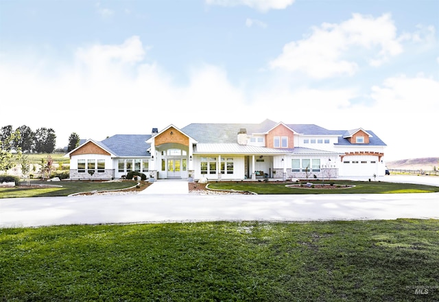 view of front of property featuring a front yard and french doors