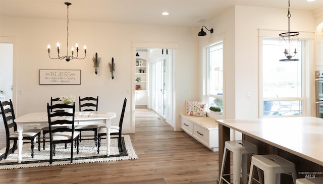 dining area with a notable chandelier and wood-type flooring