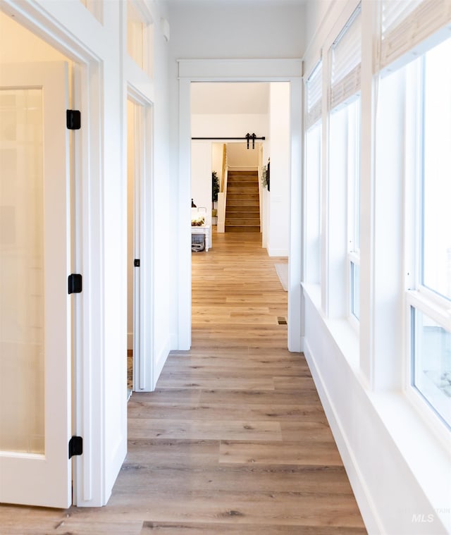 corridor with light hardwood / wood-style flooring