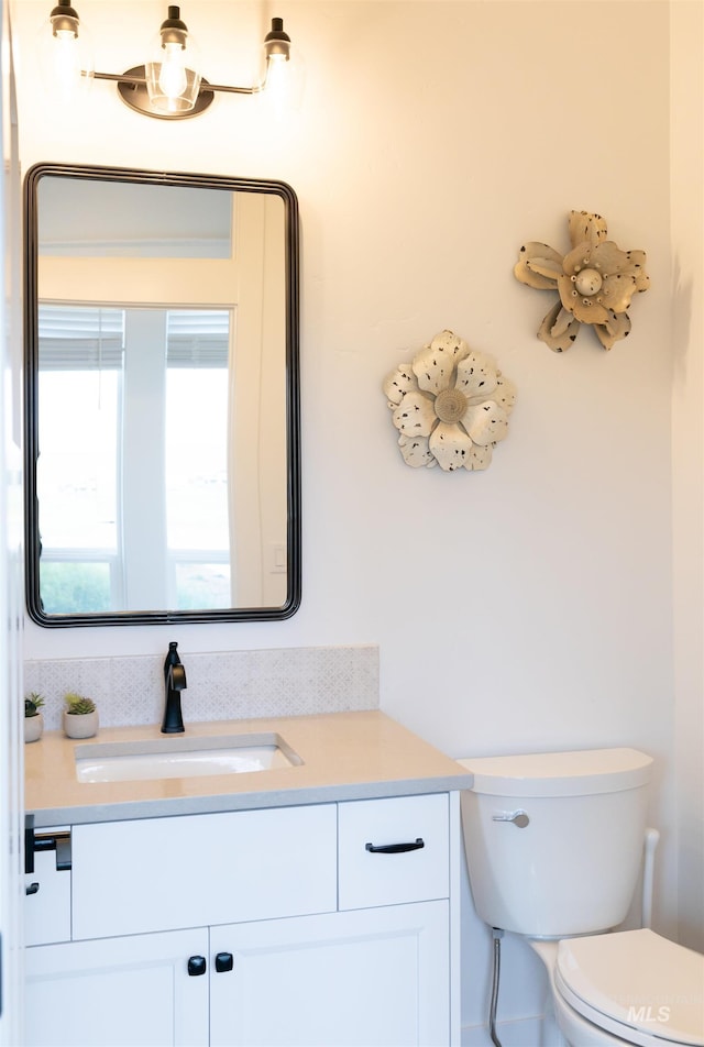 bathroom featuring vanity and toilet