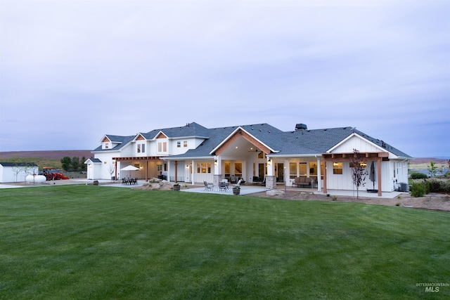 back of house featuring a yard and a patio area