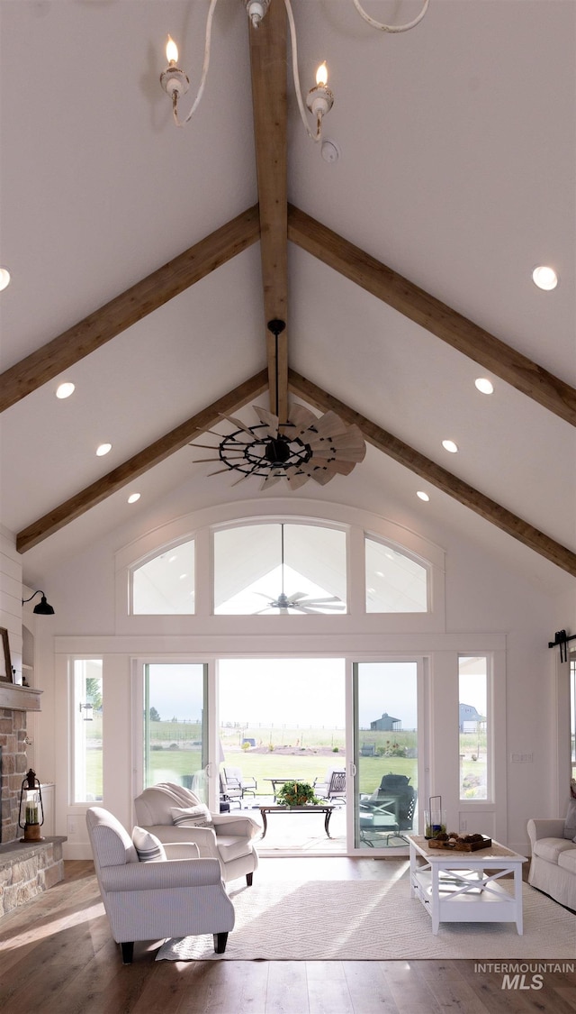 living room featuring ceiling fan, a fireplace, lofted ceiling with beams, and hardwood / wood-style flooring