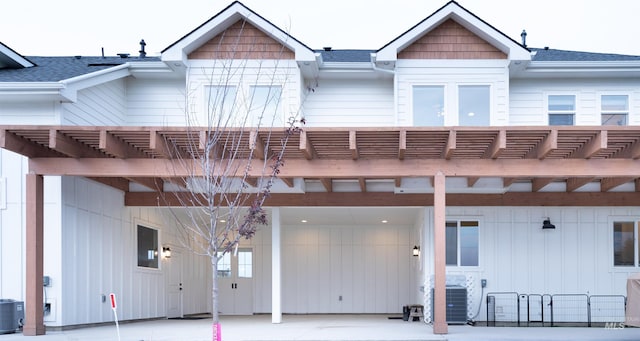 view of front of home featuring a pergola and central AC