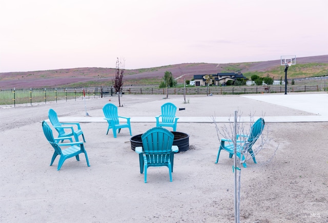 view of property's community featuring a fire pit and a mountain view