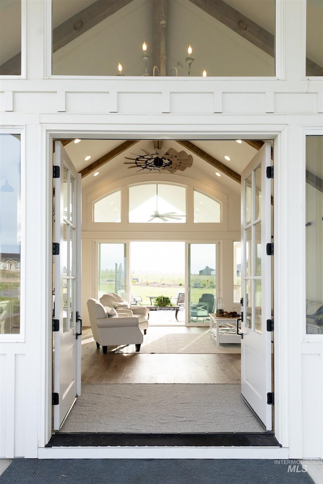 sunroom / solarium with vaulted ceiling with beams and french doors