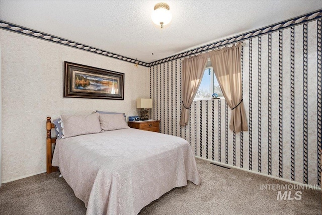 bedroom featuring carpet floors and a textured ceiling