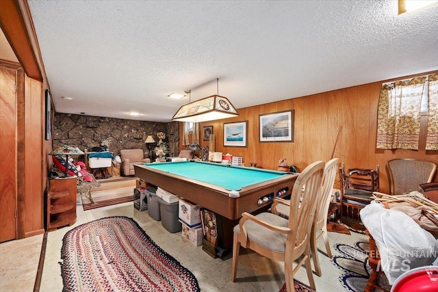 playroom with pool table, a textured ceiling, and wood walls