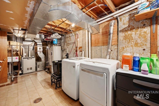 clothes washing area with washer and clothes dryer
