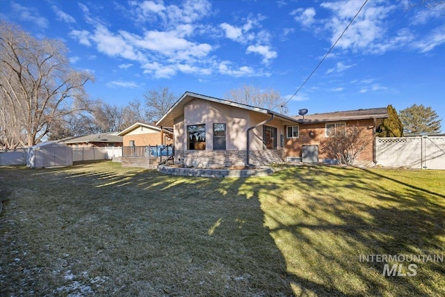 back of house with a lawn