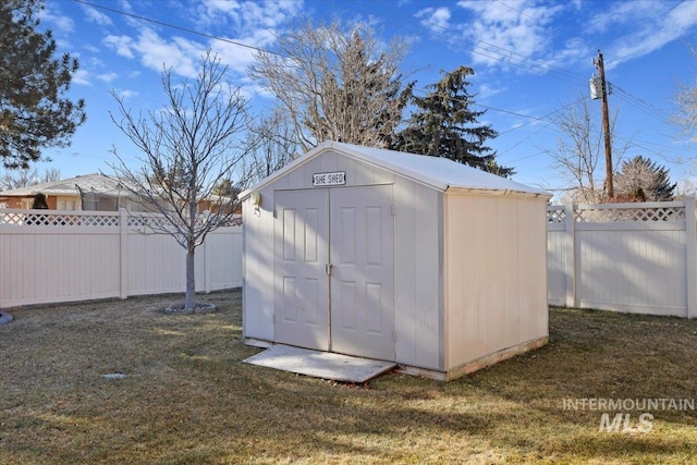 view of outbuilding with a yard