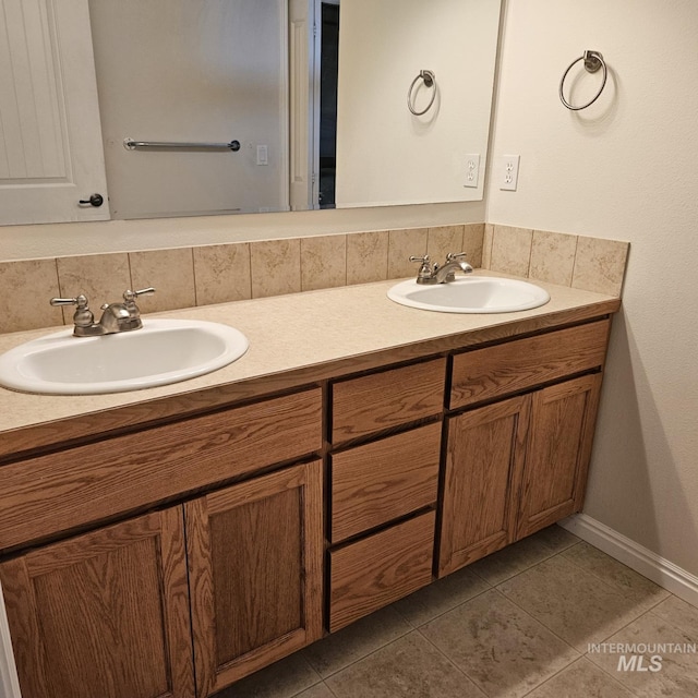 bathroom featuring tile patterned floors, vanity, and tasteful backsplash