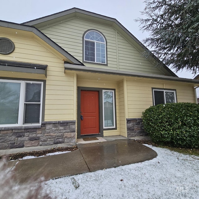 view of snow covered property entrance