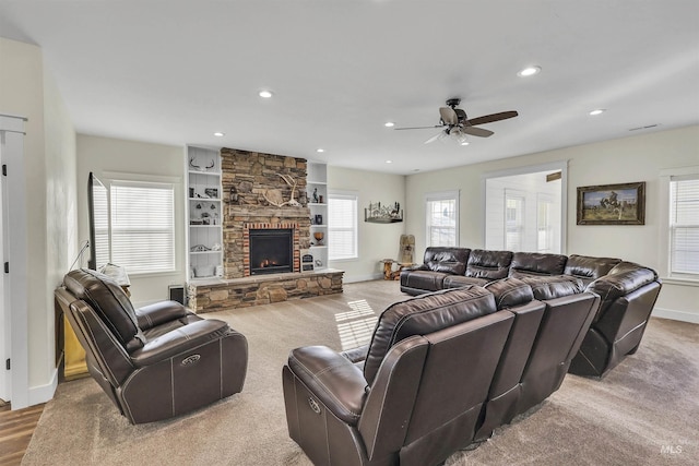 carpeted living room featuring baseboards, a fireplace, and recessed lighting