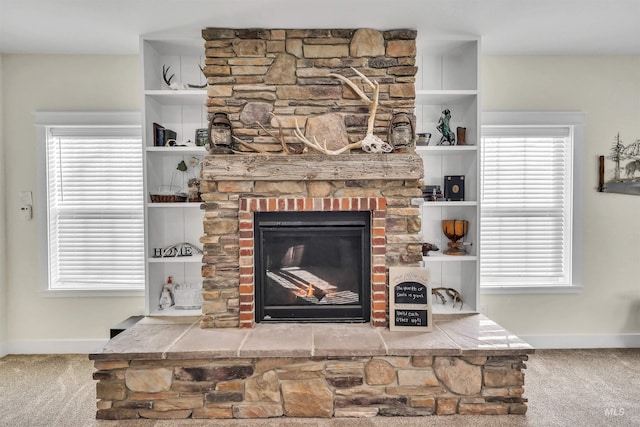 interior details with a fireplace, baseboards, and carpet flooring