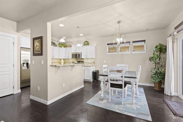 5359 N Landon Creek Pl, Meridian, ID 83646 - dining room featuring dark wood-type flooring, a chandelier, visible vents, and baseboards