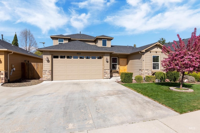 5359 N Landon Creek Pl, Meridian, ID 83646 - view of front facade featuring a garage, concrete driveway, stone siding, fence, and a front yard