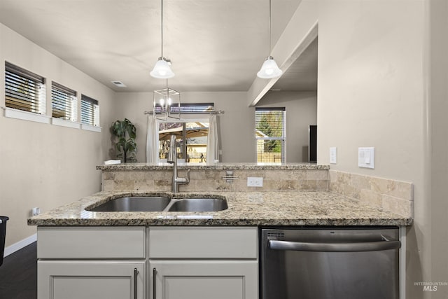 5359 N Landon Creek Pl, Meridian, ID 83646 - kitchen with dark wood finished floors, stainless steel dishwasher, light stone counters, and a sink