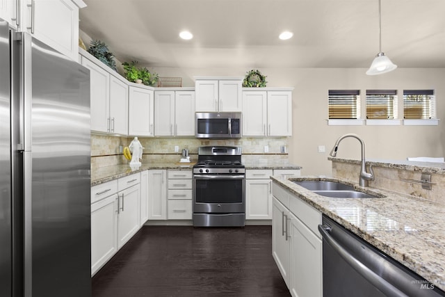 5359 N Landon Creek Pl, Meridian, ID 83646 - kitchen with white cabinets, recessed lighting, a sink, tasteful backsplash, and appliances with stainless steel finishes