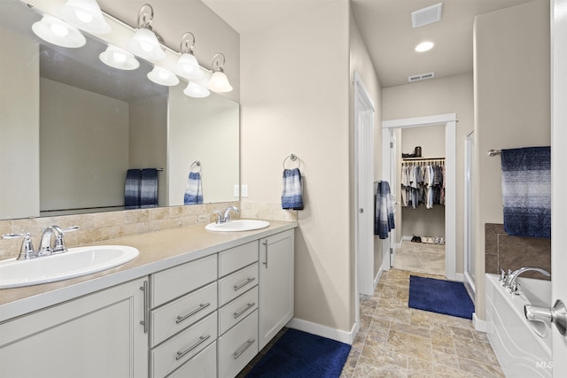 5359 N Landon Creek Pl, Meridian, ID 83646 - bathroom with double vanity, visible vents, stone finish flooring, and a sink