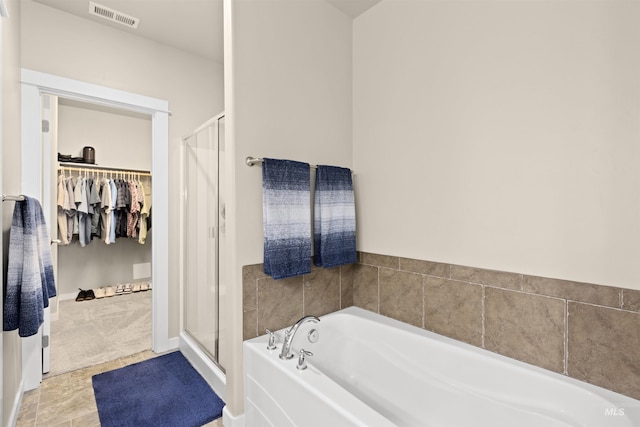 5359 N Landon Creek Pl, Meridian, ID 83646 - full bathroom featuring a walk in closet, a bath, visible vents, and a stall shower