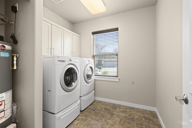 5359 N Landon Creek Pl, Meridian, ID 83646 - laundry area featuring washing machine and dryer, gas water heater, stone finish flooring, baseboards, and cabinet space