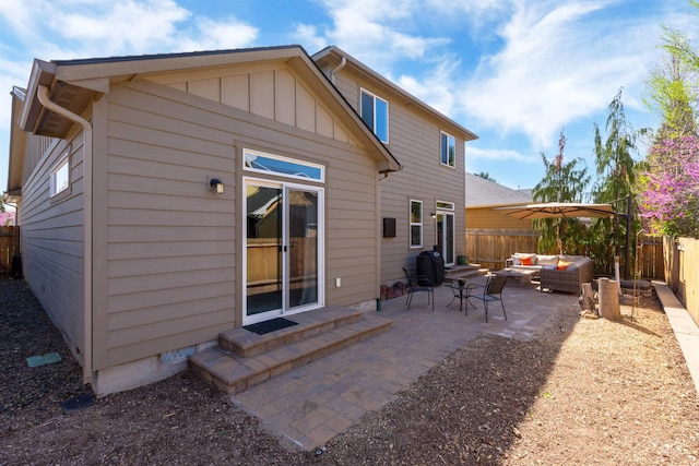 5359 N Landon Creek Pl, Meridian, ID 83646 - rear view of property featuring a fenced backyard, a patio, board and batten siding, and an outdoor hangout area