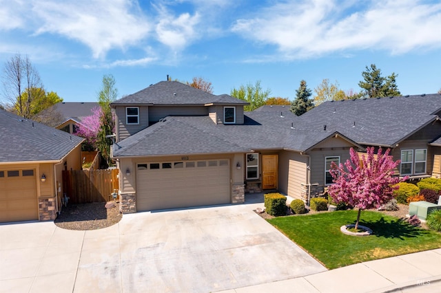 5359 N Landon Creek Pl, Meridian, ID 83646 - traditional-style home with concrete driveway, stone siding, an attached garage, fence, and roof with shingles